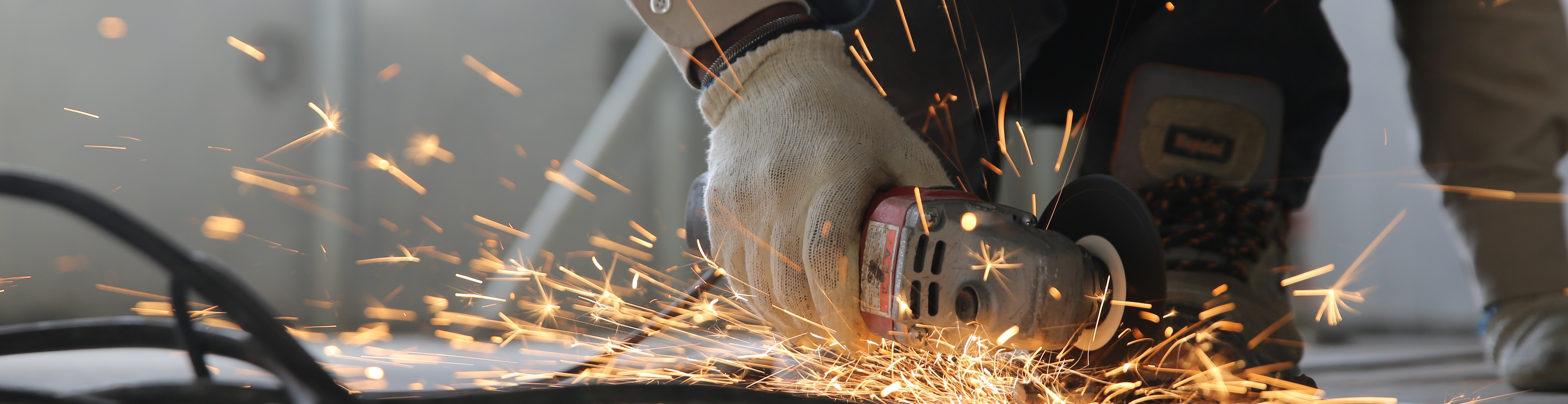 Photo of someone doing construction stuff with a lot of sparks